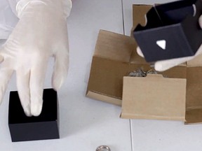 A screenshot of a video showing the unboxing of the package sent by Cards Against Humanity.
(Screenshot from YouTube)