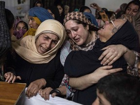 Women mourn their relative Mohammed Ali Khan, 15, a student who was killed during an attack by Taliban gunmen on the Army Public School, at his house in Peshawar on December 16, 2014. (REUTERS/Zohra Bensemra)