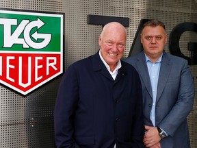 Jean-Claude Biver, head of French luxury goods group LVMH's watch business and interim CEO of the group's biggest watch brand, TAG Heuer, and general manager Guy Semon (R) pose in front of the company's logo in the western Swiss town La Chaux-de-Fonds Dec. 16, 2014.  REUTERS/Arnd Wiegmann