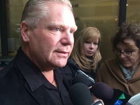 Doug Ford speaks to reporters about Rob Ford's health outside Mount Sinai Hospital on Tuesday, Dec. 16, 2014. (DON PEAT/Toronto Sun)