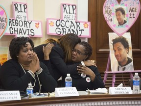 Tressa Sherrod (R) hugs Constance Malcolm alongside Collette Flanagan (L), during a press conference with other mothers who have lost children due to police action as they call for police accountability and reform on Capitol Hill in Washington, DC, December 10, 2014. (AFP PHOTO/SAUL LOEB)