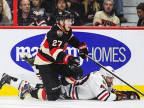 Ottawa Senators forward Curtis Lazar gets tangled up with Chicago Blackhawks forward Brandon Saad during NHL action at the Canadian Tire Centre in Ottawa Thursday October 30, 2014. (Errol McGihon/Ottawa Sun/QMI Agency)