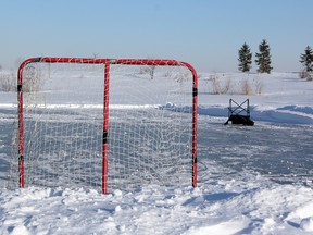 A pristine pond hockey rink in Heritage Park sits abandoned on Friday afternoon. (SHAUN BISSON/QMI AGENCY)