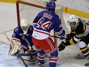 Kingston Frontenacs rookie forward Zack Dorval gets a shot on Kitchener Rangers goalie Dawson Carty as Frank Hora moves in to help during Ontario Hockey League action at the Rogers K-Rock Centre on Nov.  28.
(Ian MacAlpine/The Whig-Standard)
