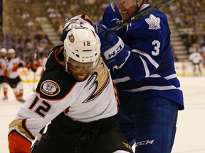 Leafs Dion Phaneuf gets physical alone the boards with Ducks Devante Smith-Pelly in the Leafs end. Toronto Maple Leafs vs. Anaheim Ducks. Leafs lead 2-1 at the end of the second period. in Toronto on Tuesday December 16, 2014. Jack Boland/Toronto Sun/QMI Agency