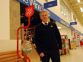 Salvation Army Capt. Mark Hall stands with a Christmas kettle in the Real Canadian Superstore in St. Thomas, Ont. (Ben Forrest, Times-Journal)