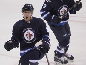 Winnipeg Jets center Mark Scheifele (l) celebrates his first goal of the second period against the Buffalo Sabres with left winger Evander Kane  during NHL hockey in Winnipeg, Man. Tuesday, December 16, 2014. The Jets are feeling good lately, firmly entrenched in a playoff spot, but stress they have a long ways to go. 
Brian Donogh/Winnipeg Sun/QMI Agency