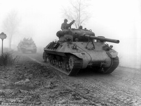 American tank destroyers move forward during heavy fog to stem the German spearhead near Werbomont, Belgium, on Dec. 20, 1944.