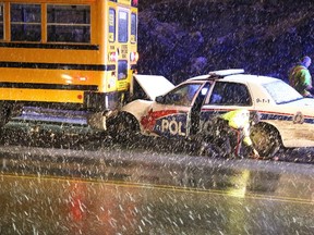 Gino Donato/The Sudbury Star

Police officers investigate a collision involving a Greater Sudbury Police Services cruiser and a school bus on Tuesday night on The Kingsway. The officer who was driving was taken to Health Sciences North with very minor injuries and released a short while later. He returned to duty upon release from HSN.