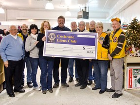 Staff of the Cochrane Food Bank and members of The Cochrane Lion's Club pose after the Lion's Club presented a cheque of $18,000 to the Food Bank. The money was raised during the Lion Bill Mitchell Telethon held recently and will go to help families in need over the holidays. The money will cover the cost of providing food vouchers.