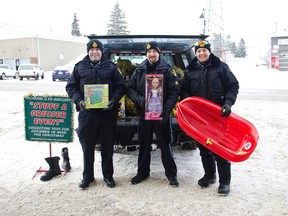Auxiliary Constable Ashley Malherbe, Auxiliary Constable Jonthan Thomas, and Constable Chris Byers pose outside of Giant Tiger with toys the collected during Saturday's Stuff a Cruiser event.