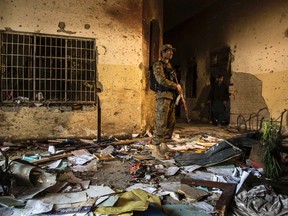 An army soldier stands inside the Army Public School, which was attacked by Taliban gunmen, in Peshawar, December 17, 2014. (REUTERS/Zohra Bensemra)