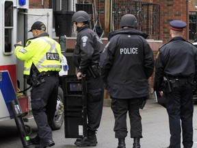 Members of Belleville police's emergency response team respond to a report of a man who locked himself in his second-floor apartment at 64 Charlotte St. in Belleville, Ont. Wednesday morning, Dec. 17, 2014.  - JEROME LESSARD/THE INTELLIGENCER/QMI AGENCY