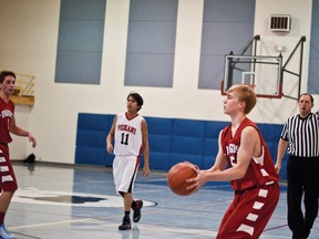 Calvin Cooley lines up his shot in the third quarter of the Dragons game against PNSS. Cooley would finish with 12 points including six from behind the arc. Greg Cowan photos/QMI Agency.