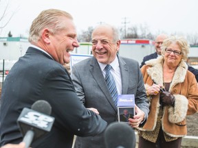 Former mayoral candidate Doug Ford, with his mother Diane Ford, shakes hands with  Humber River Hospital president and CEO Dr. Rueben Devlin on Wednesday, Dec. 17, 2014. (ERNEST DOROSZUK/Toronto Sun)