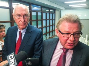 Waterfront Toronto CEO John Campbell (left) and board chairman Mark Wilson speak to reporters after the public session of a board meeting in Toronto on Wednesday, December 17, 2014. (Don Peat/Toronto Sun)