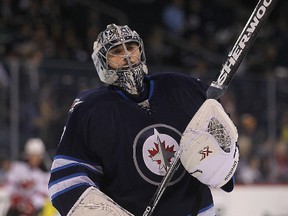 Winnipeg Jets goalie Ondrej Pavelec warms up during the pre-game skate prior to playing the New Jersey Devils in NHL hockey in Winnipeg, Man. Tuesday, November 18, 2014.Brian Donogh/Winnipeg Sun/QMI Agency