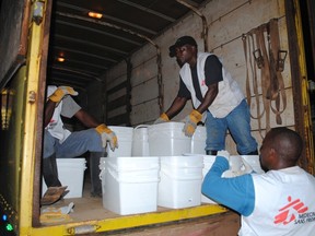 Workers for International NGO Doctors Without Borders distribute home disinfectant kits to prevent Ebola in Monrovia, Liberia, October 20, 2014. (REUTERS/James Giahyue)
