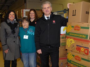 In an effort to aid community partners in St. Thomas, Christmas Care donated boxes of food Wednesday to The Caring Cupboard and The Salvation Army to assist with their food drives. Pictured from left - Karen McDade and Chris Jackson of The Caring Cupboard, Heather Beacom and Capt. Mark Hall, The Salvation Army. (Ian McCallum, Times-Journal)