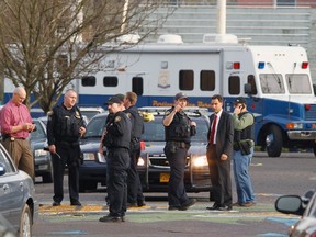 Police investigate outside the Rosemary Anderson High School in Portland, Oregon December 12, 2014.  Three teenagers were shot on Friday outside the high school, police said. REUTERS/Steve Dipaola