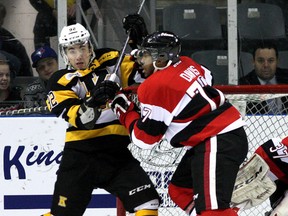 Kingston Frontenacs Corey Pawley, left, battles in front of the  Ottawa 67's net against Taylor Davis during Ontario Hockey League action at the Rogers K-Rock Centre in Kingston on Wednesday December 17 2014. Ian MacAlpine/The Kingston Whig-Standard/QMI Agency