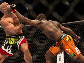 Ryan Jimmo (left) gets punched by Ovince Saint Preux (right) during UFC 174 in Vancouver on June 14, 2014. The UFC is facing a lawsuit from three MMA fighters. (Carmine Marinelli/QMI Agency/Files)