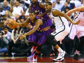 Raptors' Kyle Lowry gets away from Brandon Davies of the Brooklyn Nets on Dec. 17. (Dave Abel, Toronto Sun)