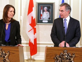Former Wildrose leader Danielle Smith and Alberta Premier Jim Prentice hold a press conference in Edmonton Alta., on Wednesday Dec. 17, 2014 to announce that Smith and eight other former Wildrose MLA's are joining the Progressive Conservatives.
David Bloom/Edmonton Sun/QMI Agency