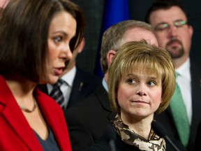 Wildrose Party leader Danielle Smith (left) speaks while MLA Kerry Towle listens during the launch of the Wildrose Caucus Foundation at the party's offices in Edmonton, Alta., on Monday, March 18, 2013. The party's MLAs will donate a pay raise approved by Progressive Conservative MLAs to the foundation, which is a registered charity. Ian Kucerak/Edmonton Sun/QMI Agency