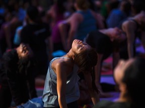 People practice yoga in Times Square as part of a Summer Solstice celebration in New York June 21, 2014. REUTERS/Eric Thayer