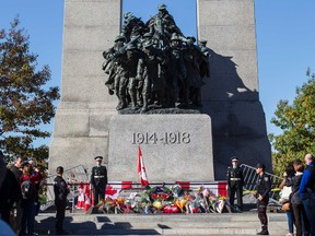 Sentries return to the Tomb of the Unknown Soldier during a ceremony at the National War Memorial in Ottawa Oct. 24, 2014.  Cpl. Nathan Cirillo was shot and killed at the National War Memorial on Oct. 22. (Errol McGihon/QMI Agency)