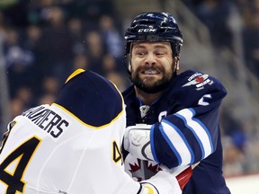 Mark Stuart fights with Buffalo's Nicolas Deslauriers Dec. 16, 2014.