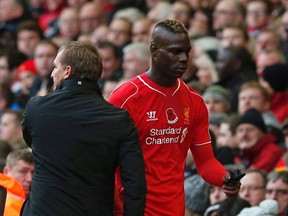 Liverpool's Mario Balotelli (R) leaves the pitch after being substituted by manager Brendan Rodgers during their English Premier League soccer match against Chelsea at Anfield in Liverpool, northern England, November 8, 2014. (REUTERS)