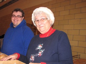 Justin McLaren, left, and Cora Van Brunschot were among 400 volunteers who packed 1,500 food baskets for the Chatham Goodfellows campaign on Thursday.