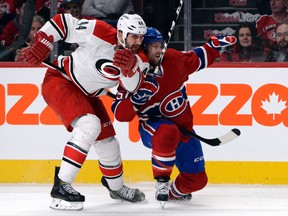 Montreal, Quebec, CAN; Carolina Hurricanes defenseman Jay Harrison (44) checks Montreal Canadiens forward David Desharnais (51) during the third period at the Bell Centre. Eric Bolte-USA TODAY Sports