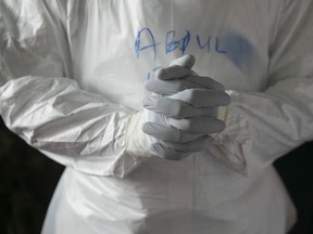 A Sierra Leonean doctor practises wearing protective clothing in the Ebola Training Academy in Freetown, Sierra Leone, December 16, 2014. 
REUTERS/Baz Ratner