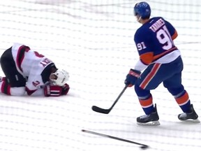Islanders captain John Tavares watches on as Devils blueliner Marek Zidlicky winces in pain following a spear. (YouTube screen grab)