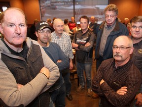 Brunkild area farmer Jurgen Kohler (left) and other farmers (l-r) Bert de Rocquigny, Menno Friesen, Jean Dion, Mark Rensch, David Laudin and Calvin Penner gather in Winnipeg, Man. Thursday Dec. 18, 2014. The farmers are upset that the government is moving ahead with plans to expropriate farmland for Bipole III.