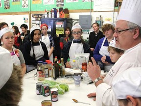 Chef Thomas Elia from St. Lawrence College begins his instruction in the use of a slow cooker to students taking part in a pilot program at First Avenue Public School on Thursday. (Michael Lea/The Whig-Standard)