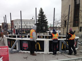 Workers set up a rink on Thursday for this weekend's Rogers Hometown Hockey Tour event in Springer Market Square. The road closures in the downtown have upset some business owners. (Elliot Ferguson/The Whig-Standard)