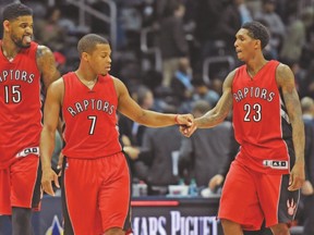 Raptors’ (left to right) Amir Johnson, Kyle Lowry and Lou Williams celebrate after a win against the Hawks earlier this season. (USA TODAY SPORTS)