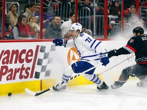 Maple Leafs forward David Clarkson (left) gets to the puck ahead of Hurricanes defencemen Tim Gleason in Raleigh, N.C., last night. (USA TODAY)