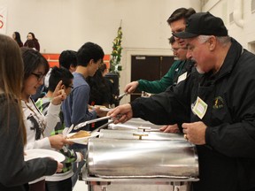 Community members serve up pancakes at the annual McNally pancake breakfast on Thursday. (Claire Theobald/Edmonton Sun)