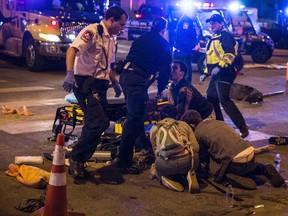 A victim who was struck by a vehicle on Red River Street during the SXSW festival is assisted by paramedics and bystanders in downtown Austin, Texas on March 13, 2014. (REUTERS/Colin Kerrigan)