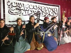 Militants, who the Pakistan Taliban say attacked the Army Public School in Pehawar on Tuesday, pose with weapons and Khalifa Omar Mansoor Hafzullah (C, in blue) at an unknown location in this undated handout picture released on December 17, 2014. Pakistan on Wednesday began burying 132 students killed in a grisly attack on their school by Taliban militants that has heaped pressure on the government to do more to tackle an increasingly aggressive Taliban insurgency. REUTERS/Pakistan Taliban/Handout