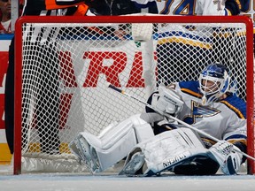 Martin Brodeur of the St. Louis Blues gets knocked into the net during the third period against the New York Islanders at the Nassau Veterans Memorial Coliseum on December 6, 2014 in Uniondale, New York. (Bruce Bennett/Getty Images/AFP)