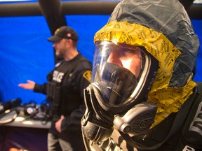OPP officers demonstrated the chemical resistant gear they wear when entering a drug lab. Mike Hensen/The London Free Press/QMI Agency