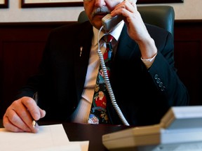 Alberta Legislature Speaker Gene Zwozdesky answers the phone in his office at the Alberta Legislature in Edmonton, Alta., on Monday, Dec. 23, 2013. Zwozdesky speaks with sad constituents over the holidays. Ian Kucerak/Edmonton Sun