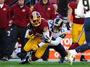 Washington Redskins wide receiver Santana Moss (89) is tackled by St. Louis Rams free safety Rodney McLeod (23) during the second half at FedEx Field on Dec 7, 2014 in Landover, MD, USA. (Brad Mills/USA TODAY Sports)