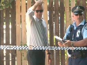 Queensland state police Detective Inspector Bruno Asnicar (L) stands with police officers at the crime scene where a mass stabbing took place, in the suburb of Manoora in Cairns in this December 19, 2014 still image taken from video provided by Australian Broadcasting Corporation (ABC). Eight children have been killed and a woman injured, police said on Friday, during what several media outlets reported was a mass stabbing. Queensland state police said in a statement they were called to the house in Manoora just before midday after reports of a woman with serious injuries on the premises. They found the bodies of the children, aged between 18 months and 15 years, when they were examining the location. REUTERS/ABC/Reuters TV